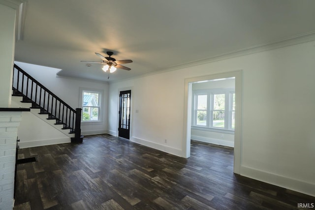 unfurnished living room featuring crown molding, dark wood-type flooring, and ceiling fan