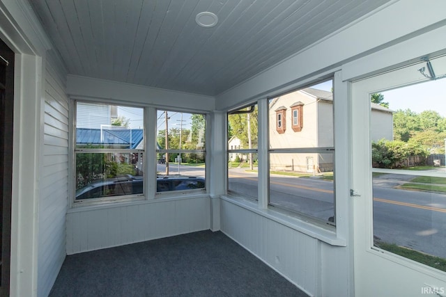 unfurnished sunroom featuring wooden ceiling