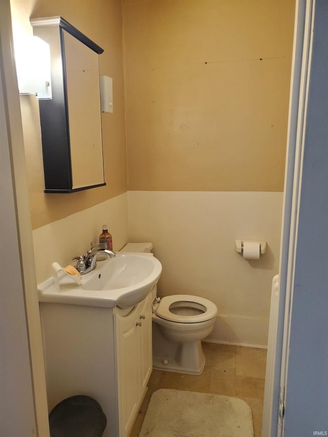 bathroom featuring tile patterned floors, vanity, and toilet