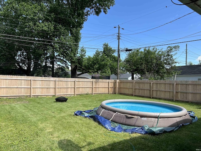 view of pool with a yard