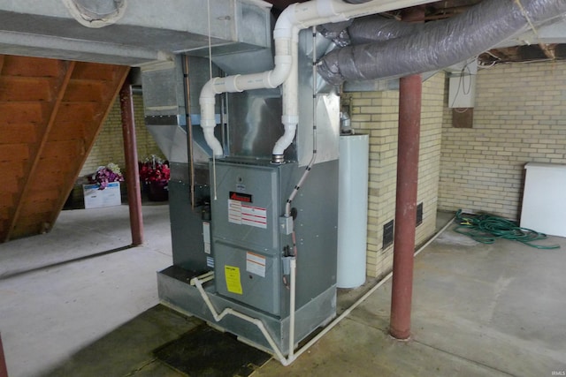 utility room featuring gas water heater and heating unit