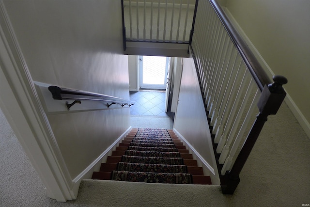 stairs with carpet flooring and a high ceiling