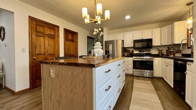 0 N State Road 450, Shoals, IN 47581 - kitchen with black appliances, a chandelier, a sink, dark wood-style floors, and a center island