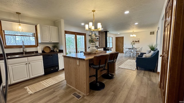 0 N State Road 450, Shoals, IN 47581 - kitchen featuring dishwasher, a chandelier, a textured ceiling, a sink, and wood finished floors