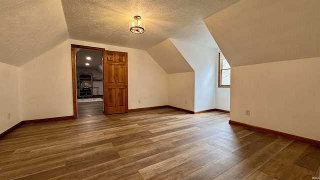 0 N State Road 450, Shoals, IN 47581 - additional living space with a textured ceiling, wood finished floors, vaulted ceiling, and baseboards