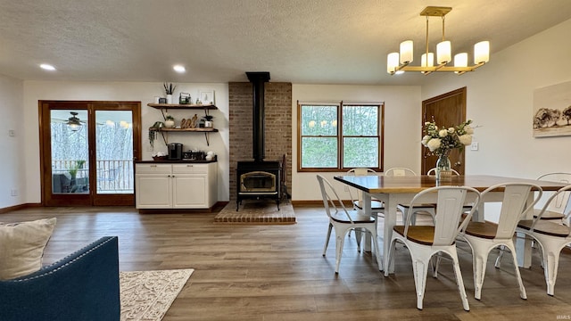0 N State Road 450, Shoals, IN 47581 - dining area with a wood stove, a textured ceiling, wood finished floors, a chandelier, and baseboards