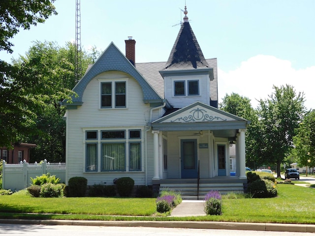 victorian-style house with covered porch and a front yard