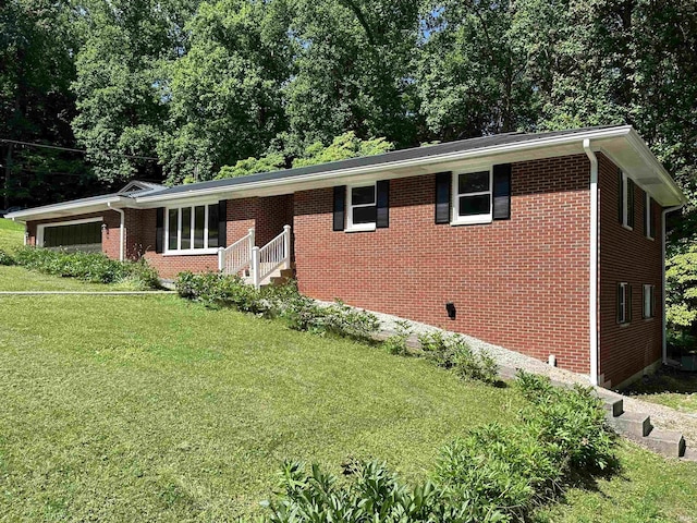 single story home with a front yard and a garage