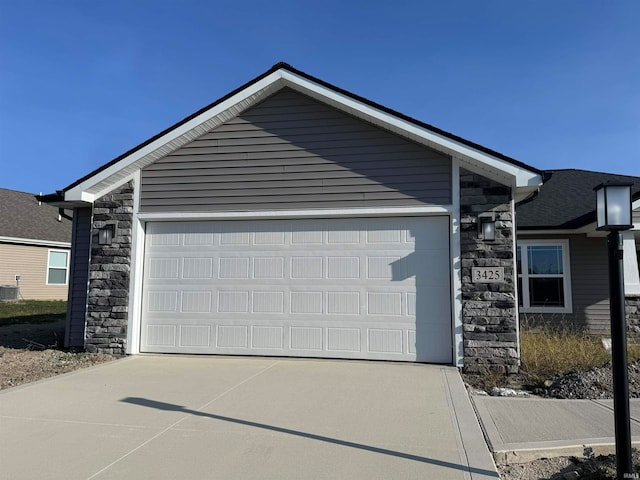 view of front facade with central AC and a garage