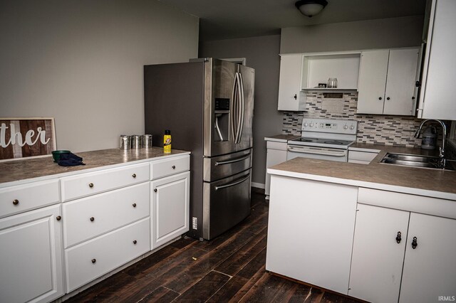 kitchen with stainless steel refrigerator with ice dispenser, white electric range, white cabinets, and sink