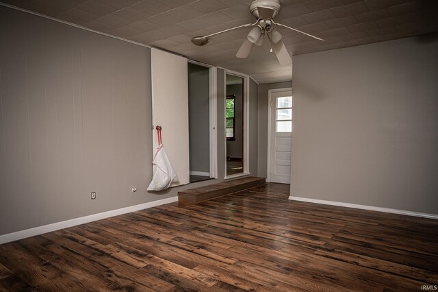 unfurnished room with ceiling fan and dark wood-type flooring