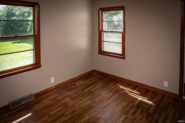 empty room with dark hardwood / wood-style flooring