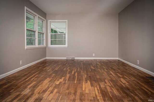 unfurnished room featuring dark hardwood / wood-style floors