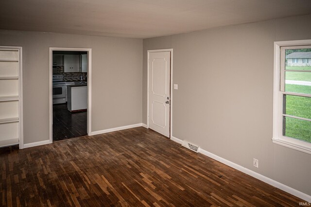 unfurnished bedroom featuring dark hardwood / wood-style flooring