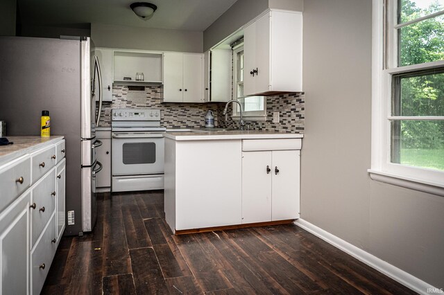 kitchen featuring white cabinets, white electric range, dark hardwood / wood-style floors, and stainless steel fridge