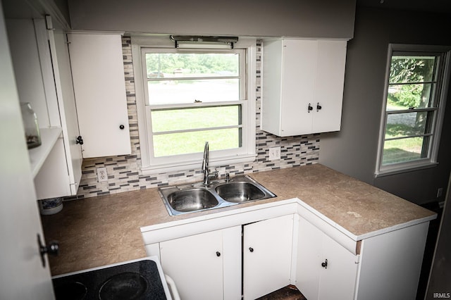 kitchen with white cabinetry, sink, and a healthy amount of sunlight