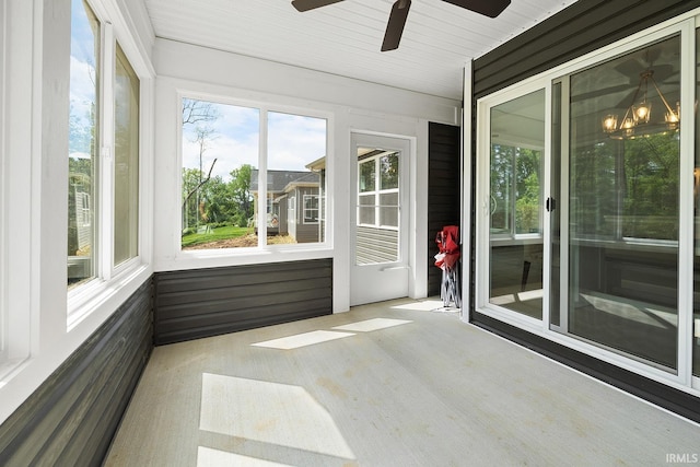 unfurnished sunroom with ceiling fan