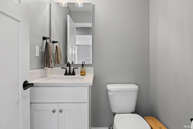 bathroom with toilet and vanity