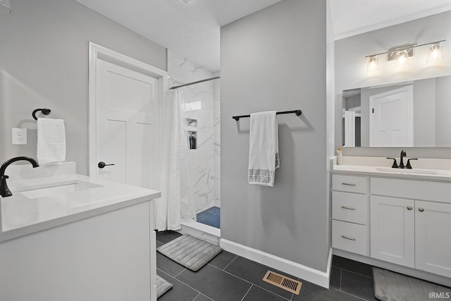 bathroom with tile patterned flooring, vanity, and walk in shower