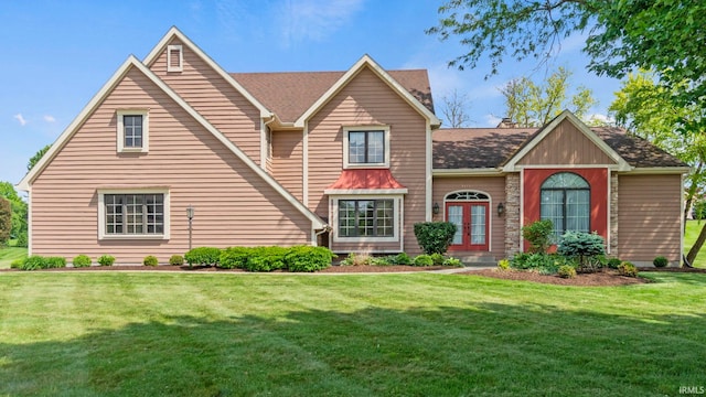 view of front of house with french doors and a front lawn