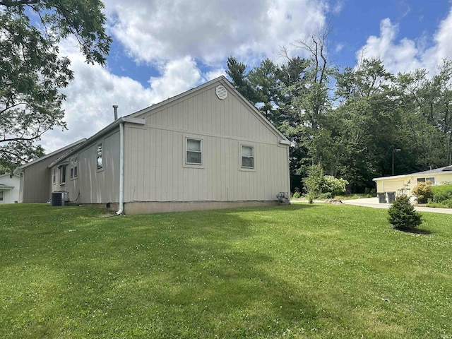 view of side of property featuring a yard and central air condition unit