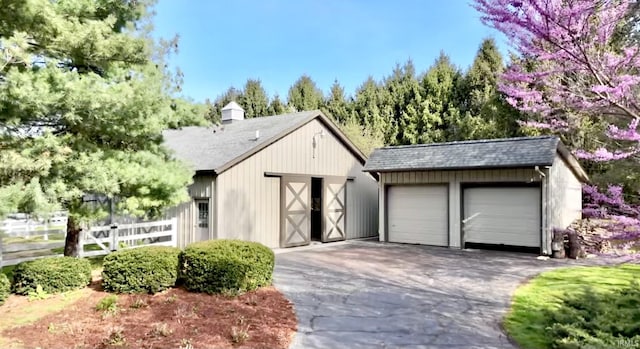 view of front of house featuring a garage and an outdoor structure