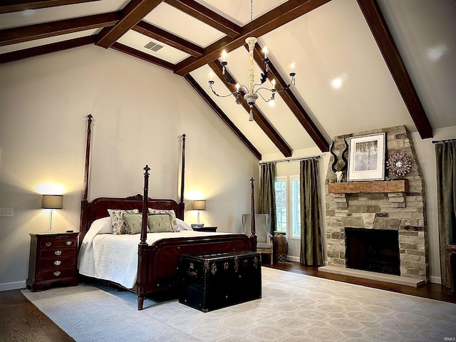 bedroom with a notable chandelier, beam ceiling, wood-type flooring, and a fireplace