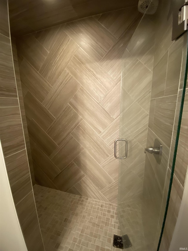 bathroom with a shower with door