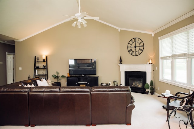 living area featuring lofted ceiling, a glass covered fireplace, light colored carpet, and crown molding