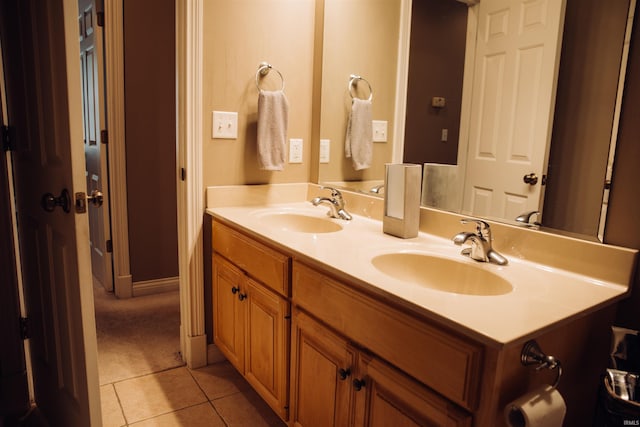 bathroom with double vanity, tile patterned flooring, and a sink