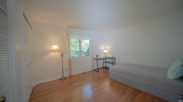 bedroom featuring light wood-type flooring and a closet