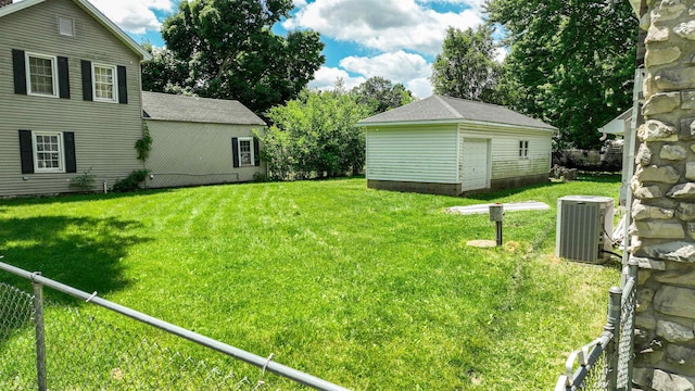 view of yard featuring a shed and central AC unit