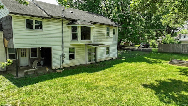 rear view of house with a lawn