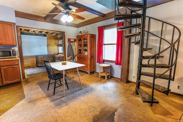 dining area with hardwood / wood-style floors, ceiling fan, and beamed ceiling