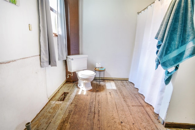 bathroom featuring hardwood / wood-style flooring and toilet