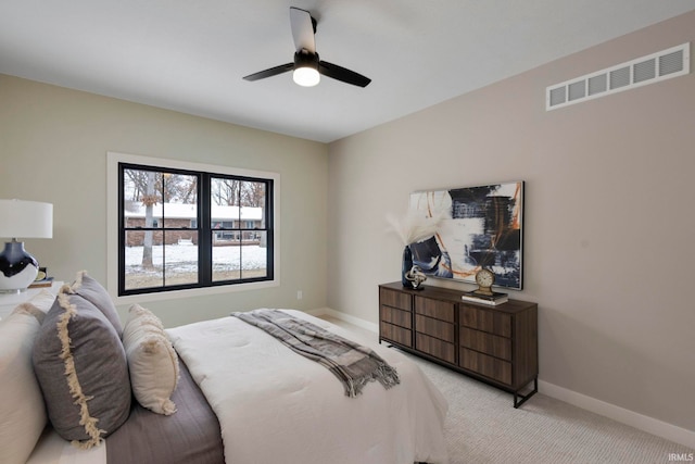 bedroom featuring visible vents, baseboards, light colored carpet, and ceiling fan