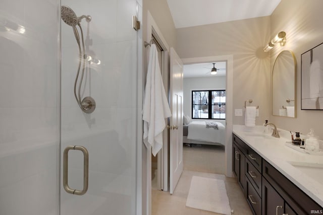 ensuite bathroom with a sink, connected bathroom, double vanity, and a shower stall