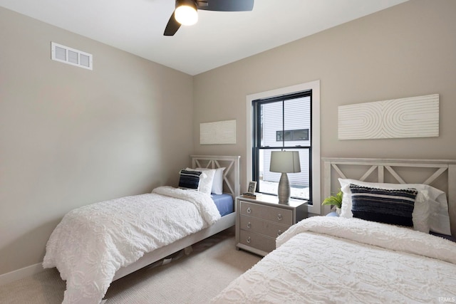 carpeted bedroom featuring visible vents, baseboards, and ceiling fan