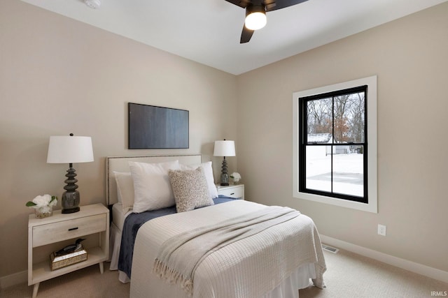 bedroom with visible vents, baseboards, carpet floors, and ceiling fan