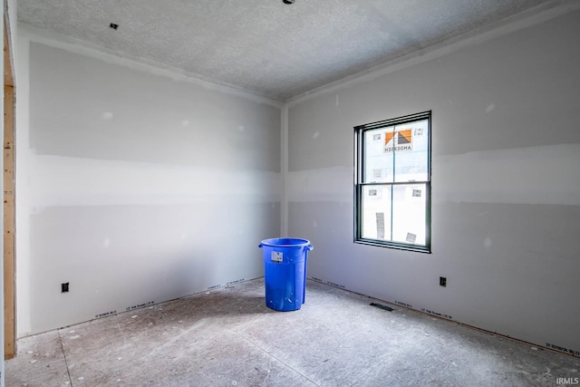 empty room featuring a textured ceiling