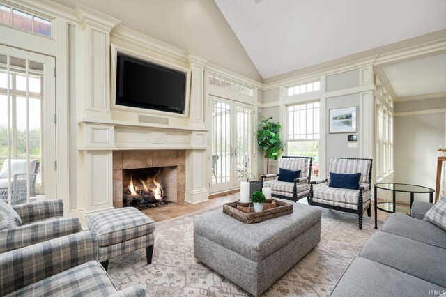 living room featuring light tile patterned flooring and high vaulted ceiling