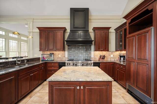 kitchen featuring decorative backsplash, light stone countertops, and sink