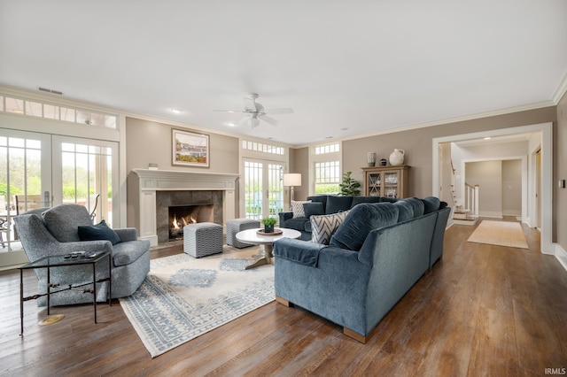 living room with ceiling fan, crown molding, and light wood-type flooring