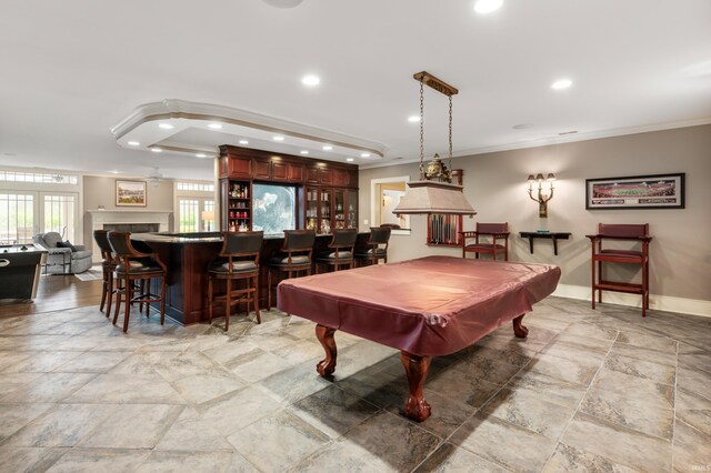 game room featuring ornamental molding, indoor bar, and billiards