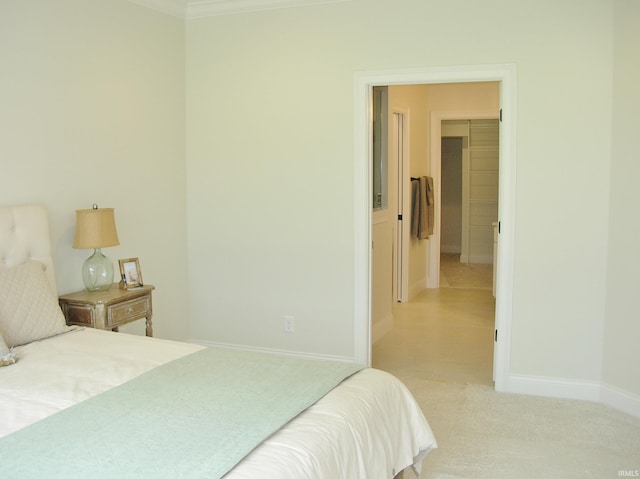 bedroom featuring a closet, light colored carpet, and ornamental molding