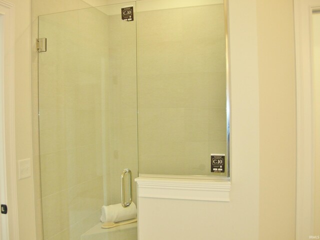 bathroom with a shower with shower door