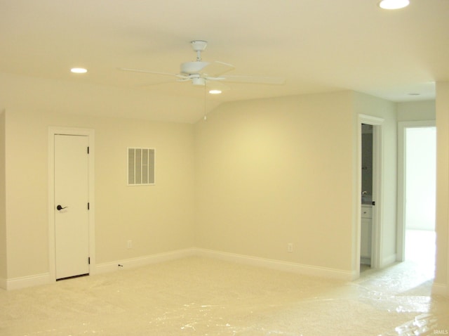 spare room with ceiling fan and vaulted ceiling