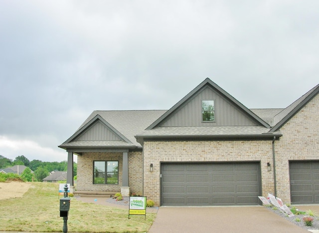 view of front of property with a garage and a front lawn