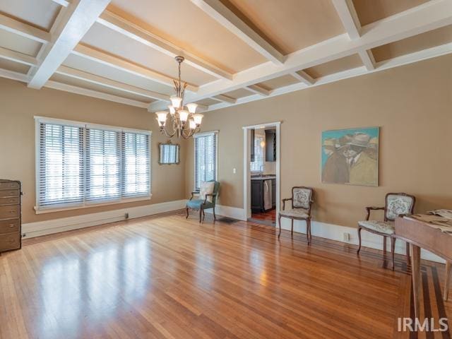 sitting room with beamed ceiling, a notable chandelier, and wood-type flooring