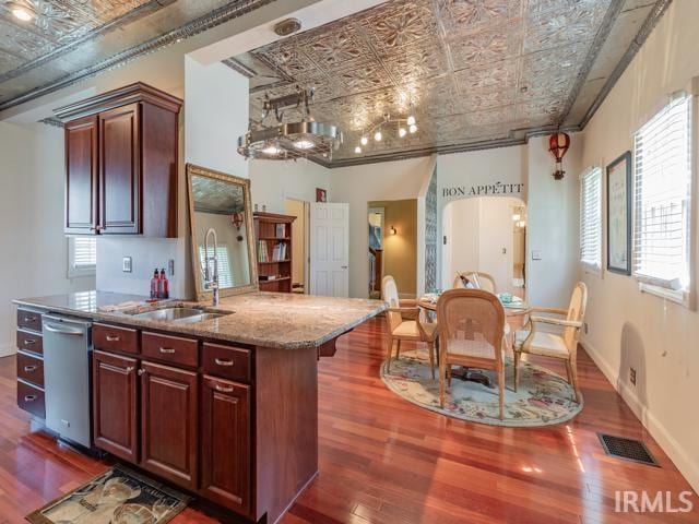 kitchen featuring dishwasher, dark wood-type flooring, and a healthy amount of sunlight